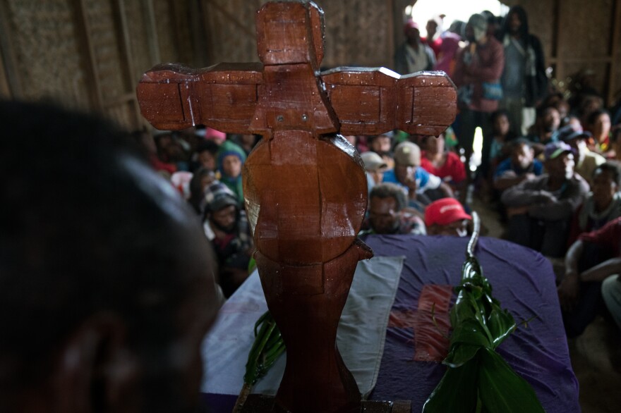 During a reconciliation meeting at a church in Henganofi, members of two clans sit listening to speeches from the police, local religious leaders, a member of the Kafe Urban Settlers Women's Association and others.