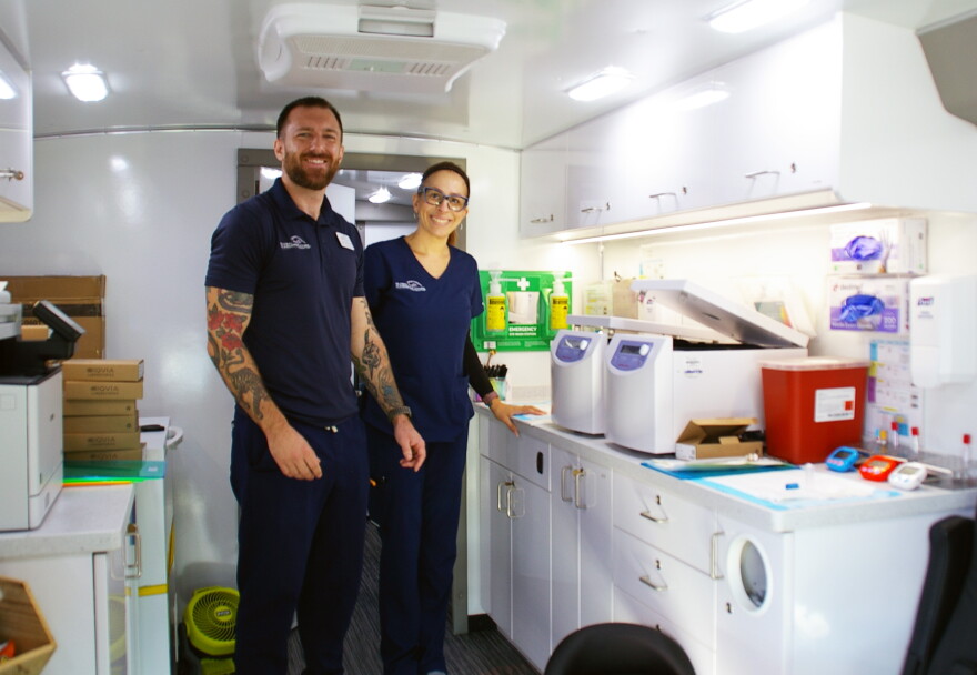 Representatives from the Global Alzheimer’s Platform Foundation prepare the mobile unit for cognitive assessments and blood testing on Friday, Sept. 25, 2026. (Catherine Chapman/WUFT News)