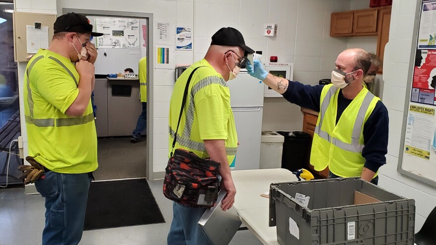 Temperature checks have become routine for the crews who man garbage trucks in Lawrence.