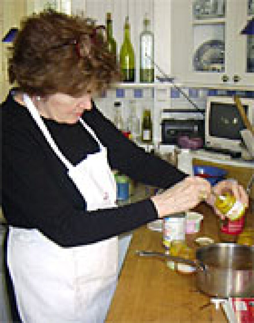 Linda Wertheimer spoons out baby food in preparing butternut squash and apple soup.