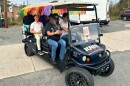 Volunteers transport voters from the Day of the Dead festival to a polling site at Camp North End on Sat., Nov. 4, 2024.