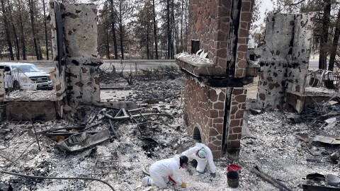 Archaeologists from the Alta Heritage Foundation sift through the rubble of CaitLynn and Keenan Burt's Spokane home.