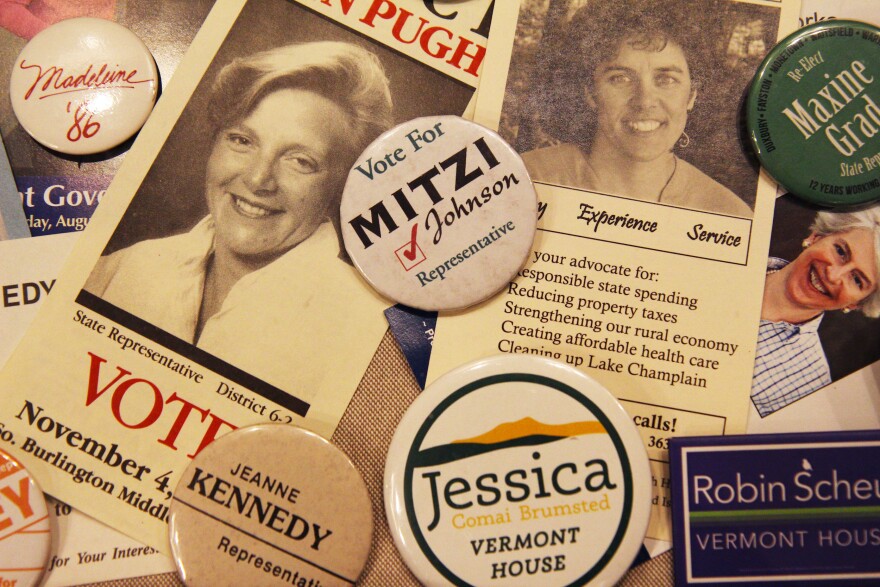 A campaign button for Mitzi Johnson among other various buttons and flyers.