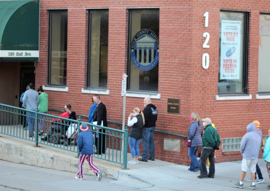 People line up on the first day for early voting at the Polk County Election Office Oct. 5, 2020.