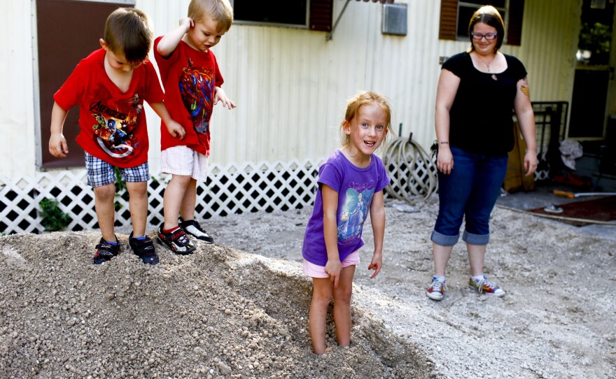 Katrina Bordwell's home was flooded recently after nearby development stopped up a drainage pipe. Bordwell, 24, lives in the community with her children, from left, Leo, 3, her boyfriend's son Kyle Cose, 3, and Zoey, 5.