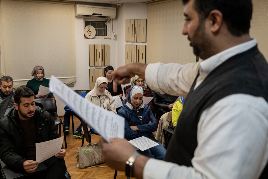 Ibrahim Muslimani, 30, speaks to a class about a piece of music blending different eras and languages at the Nefes Foundation for Arts and Culture, which he founded in 2016, in Gaziantep, Turkey, on Nov. 22, 2022.