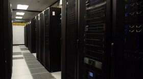 Racks of servers line a corridor at the University of Virginia's data center.