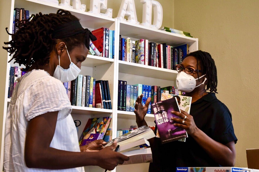 Kathy Burnette, owner of Brain Lair Books in South Bend, gives a customer recommendations on new books.