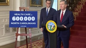 North Carolina Gov. Roy Cooper, right, speaks while state Health and Human Services Secretary Kody Kinsley listens at an Executive Mansion news conference in Raleigh, N.C., on Monday, Sept. 25, 2023. Cooper and Kinsley announced that North Carolina would launch Medicaid expansion coverage on Dec. 1. Expansion will be able to start because Cooper said he'll let a state budget bill sent by the General Assembly last week to his desk become law without his signature. (AP Photo/Gary D. Robertson)