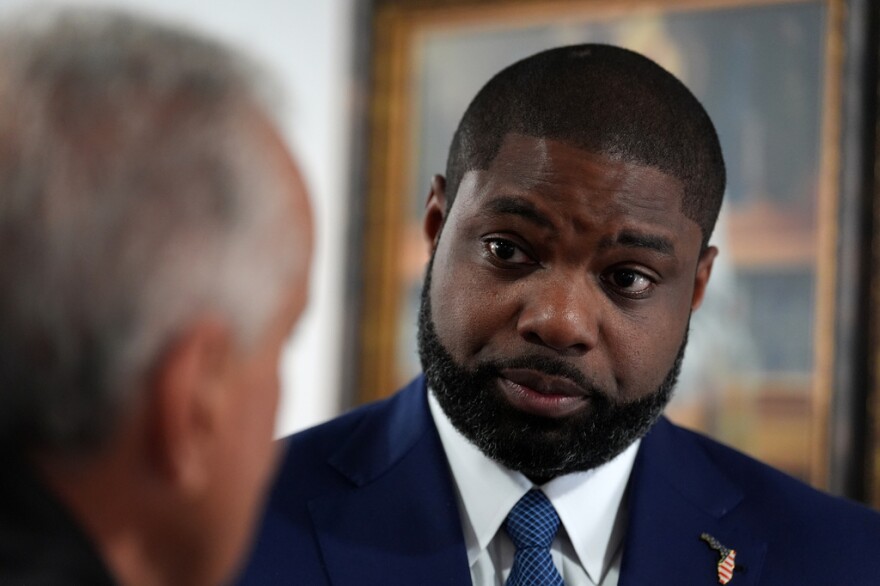 Florida Republican congressman and gubernatorial candidate Byron Donalds talks with a member of the Hispanic Police Officers Association in Doral, after receiving the group's endorsement on Aug. 6.