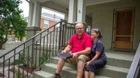 Sharon Ellsworth-Nielson, 61, and Larry Nielson, 62, sit on the front steps of their Salt Lake City home holding a black leather binder that contains their will, July, 24, 2023.