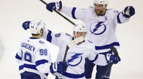 Tampa Bay Lightning center Ross Colton (79) and defenseman Victor Hedman (77) celebrate with defenseman Mikhail Sergachev (98) after Sergachev scored a goal against the New York Rangers during the second period in Game 5 of the NHL Hockey Stanley Cup playoffs Eastern Conference Finals, Thursday, June 9, 2022, in New York.