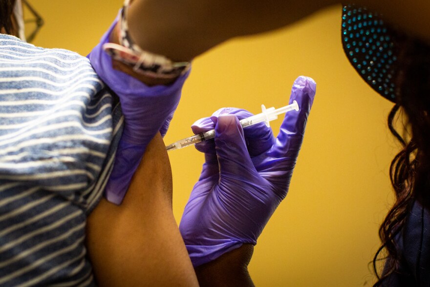 A patient receives a COVID-19 vaccine in March.