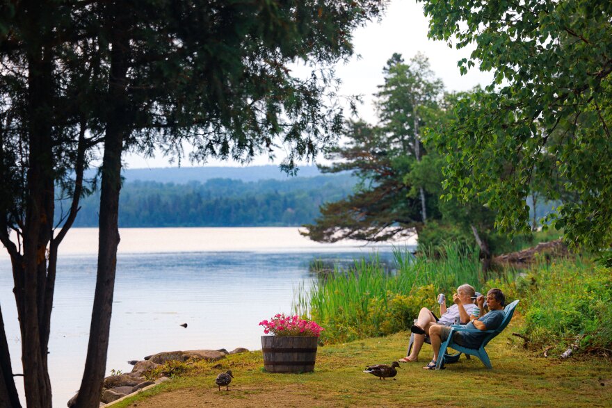 A couple eats ice cream by Haley Pond in Rangeley, Maine on June 19, 2024.