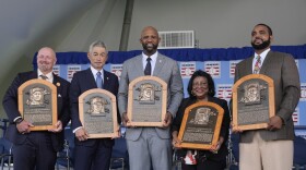 Baseball Hall of Fame inductees Billy Wagner, left, Ichiro Suzuki, second from left, and CC Sabathia, center, pose for a photo with Willa Allen, second from right, widow of Baseball Hall of Fame inductee Dick Allen, and Dave Parker II, right, son of the late Baseball Hall of Fame inductee Dave Parker, at the National Baseball Hall of Fame induction ceremony in Cooperstown, N.Y., Sunday, July 27, 2025. (AP Photo/Seth Wenig)