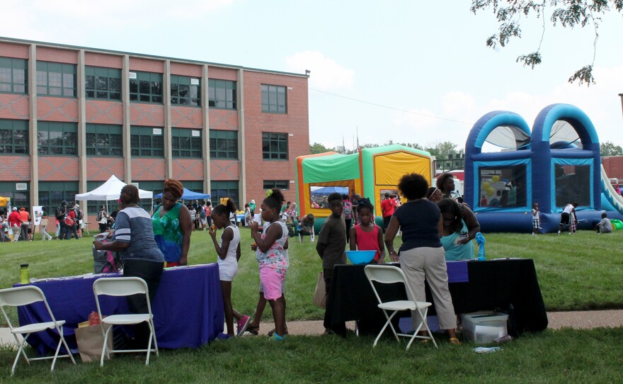 Resource tables circled two bounce houses on the lawn of Normandy High School for the back-to-school fair Saturday, August 15, 2015.