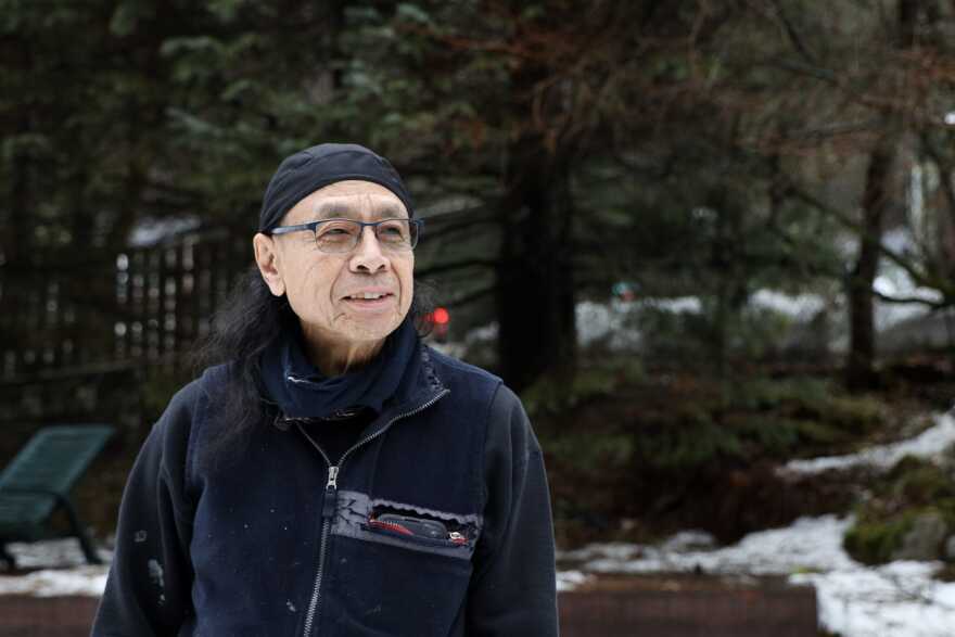 Carlos Cadiente stands in the backyard of his home kitty-corner from Juneau-Douglas High School: Yadaa.at Kalé in the Behrends slide path on Wednesday, Jan. 14, 2026.