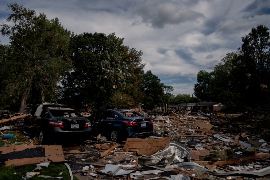 Debris and wrecked cars cover the site where homes once stood after a house explosion damaged about 20 residences on Monday, Aug. 25, 2025, near Black Jack.