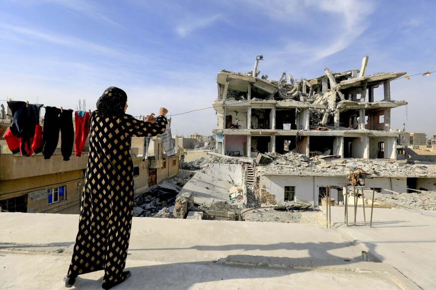 A Syrian woman hangs laundry in Raqqa, the former "capital" of the Islamic State group in Syria, on Jan. 11.