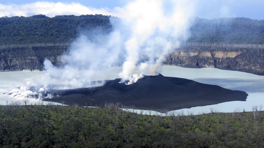 Residents of Ambae, in Vanuatu, are beginning to return home this week. In this photo from Oct. 1, that was provided by the Vanuatu Meteorological and GeoHazards Department, the volcanic cone is seen that formed in Lake Vui near the summit of Ambae Island.