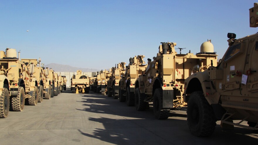 Armored vehicles known as M-ATVs are lined up on the tarmac at Bagram Air Field. They will be flown out to the Persian Gulf on cargo planes and then shipped back to the U.S.