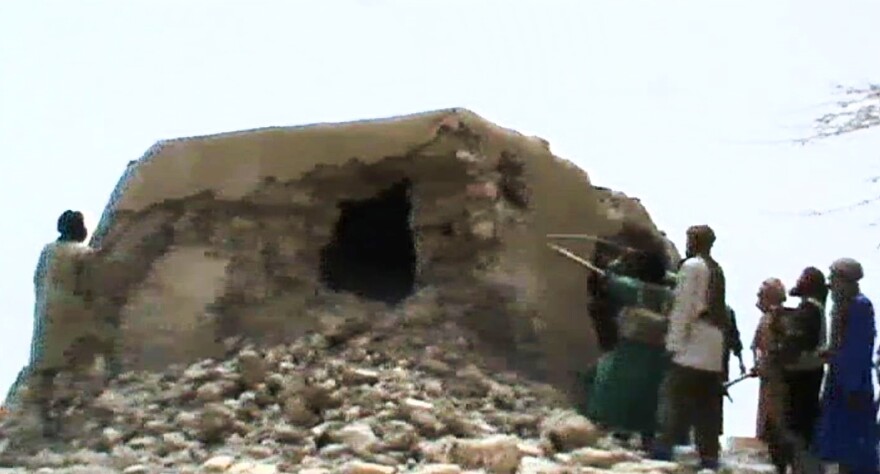 A still from a video shows Islamist militants destroying an ancient shrine in Timbuktu on July 1, 2012. At the time, the International Criminal Court warned that their campaign of destruction was a war crime. The hardline Islamists considered the shrines to be idolatrous.