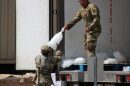 National Guard members with 41st Field Artillery Regiment of New Orleans unload bags of ice to load into vehicles at a Hurricane Ida distribution point near the Lake Charles Civic Center on Aug. 31, 2020.