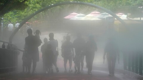 Visitors pass by the cooling fog device at Gwangmyeong Cave tourist site in Gwangmyeong, South Korea, Thursday, Aug. 6, 2026. (AP Photo/Ahn Young-joon)