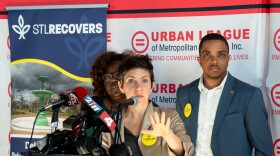 St. Louis Mayor Cara Spencer, center, speaks to a resident about tornado relief while flanked by 11th Ward Alderwoman Laura Keys, left, and the city’s Chief Recovery Office Julian Nicks, right, during a press conference at the Urban League of Metropolitan St. Louis Women’s Business Center on Tuesday, Oct. 21, 2025, in the city’s Penrose neighborhood.