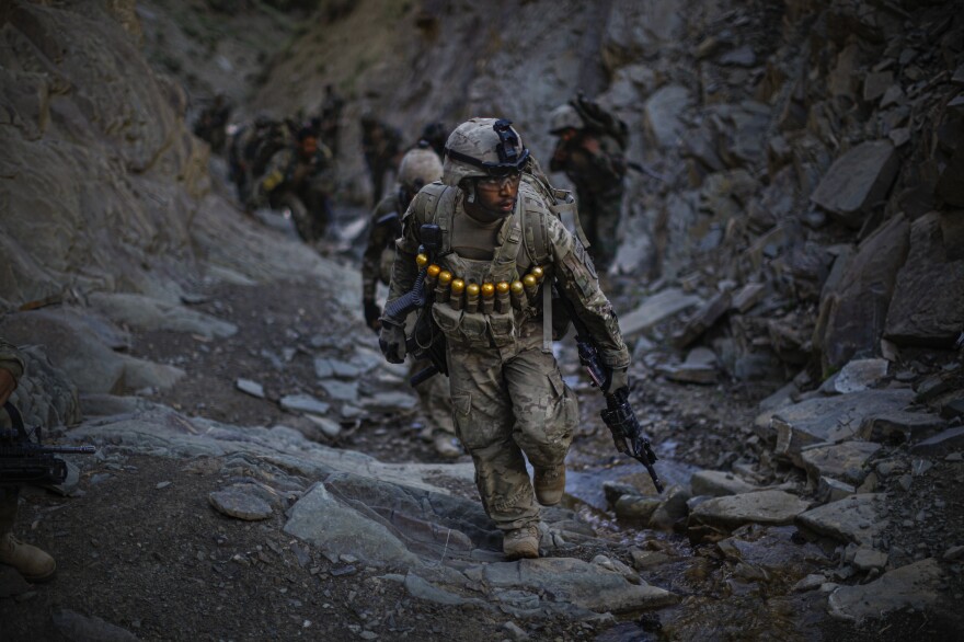 Soldiers with Butcher Troop, part of the US Army 1st Infantry Division, and Afghan National Army troops climb up the treturous mountains overlooking the Khost-Gardez highway while on a mission to disrupt insurgent fighters in the area on June 27, 2011.