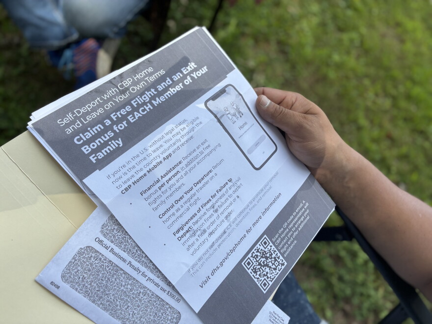 Tito Sabillón holds a flyer he received in the mail from the U.S. Department of Homeland Security encouraging undocumented immigrants to self-deport using an app from Customs and Border Protection.