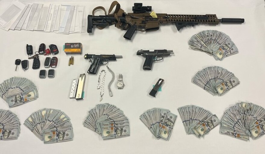 Weapons and cash seized during the investigation of a mail theft ring in Ventura County.
