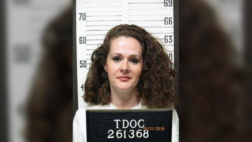 Police mug shot of a woman holding a sign that says "TDOC 261368" with the date 05/31/2016.