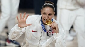 FILE - United States's Diana Taurasi bites her gold medal during the medal ceremony for women's basketball at the 2020 Summer Olympics, Sunday, Aug. 8, 2021, in Saitama, Japan. The 42-year-old guard will be playing in a record sixth Olympics when the U.S. goes for its eighth consecutive gold medal. (AP Photo/Charlie Neibergall, File)