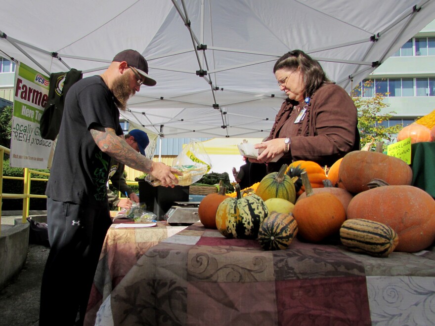 Air Force veteran Sean Michael Dalgarn works the Growing Veterans farm stand at the VA Hospital in Seattle. The group's members learn to farm and then sell its harvest here once a week through December.