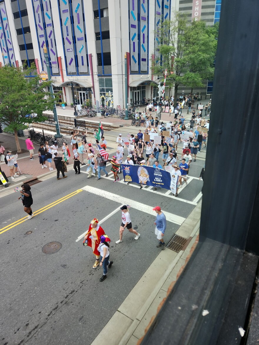 "No Kings" demonstrators march through uptown Charlotte.