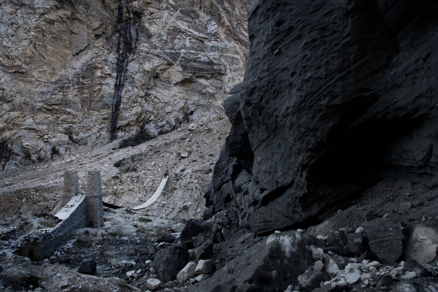 Shishper, a 9-mile-long, black glacier, is edging toward a wood-and-rope bridge that government-contracted workers are racing to dismantle.