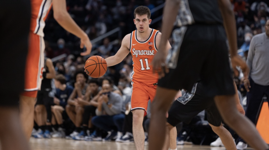 Joe Girard III dribbles the ball in a game against Georgetown.