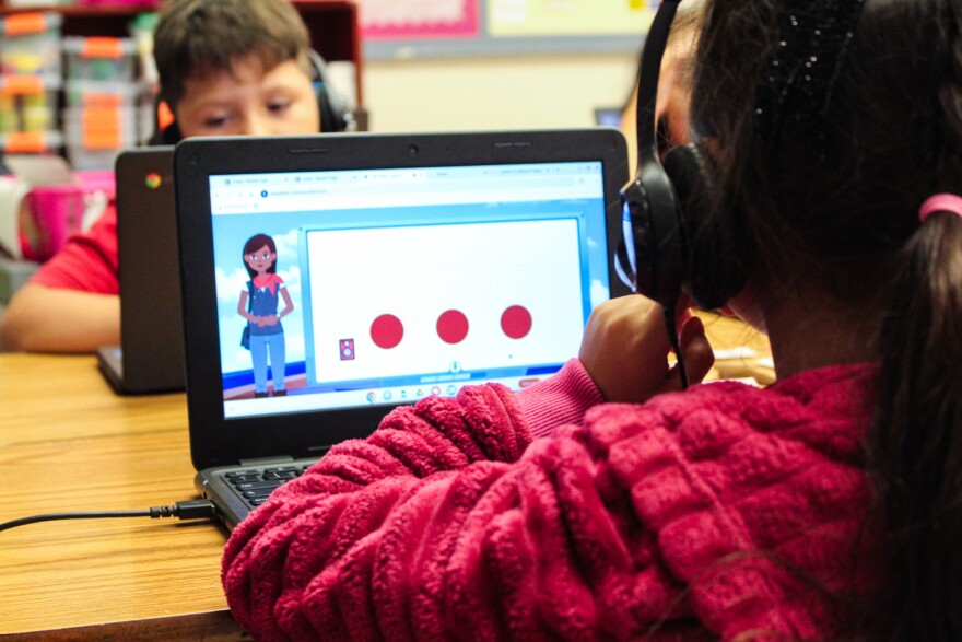 A first grader reads with the help of an AI-powered tutor at Johnson Elementary in Gretna on Sept. 23, 2023.