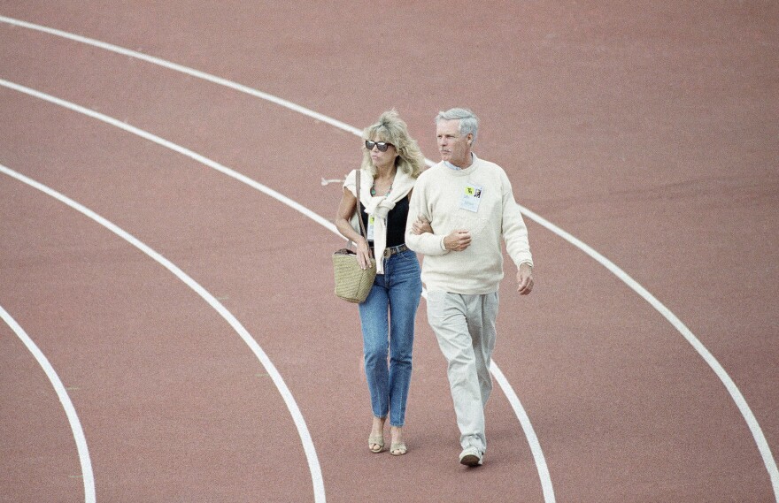 Actor Jane Fonda and medial mogul Ted Tuner walk along the track at Husky Stadium at the 1990 Goodwill Games.
