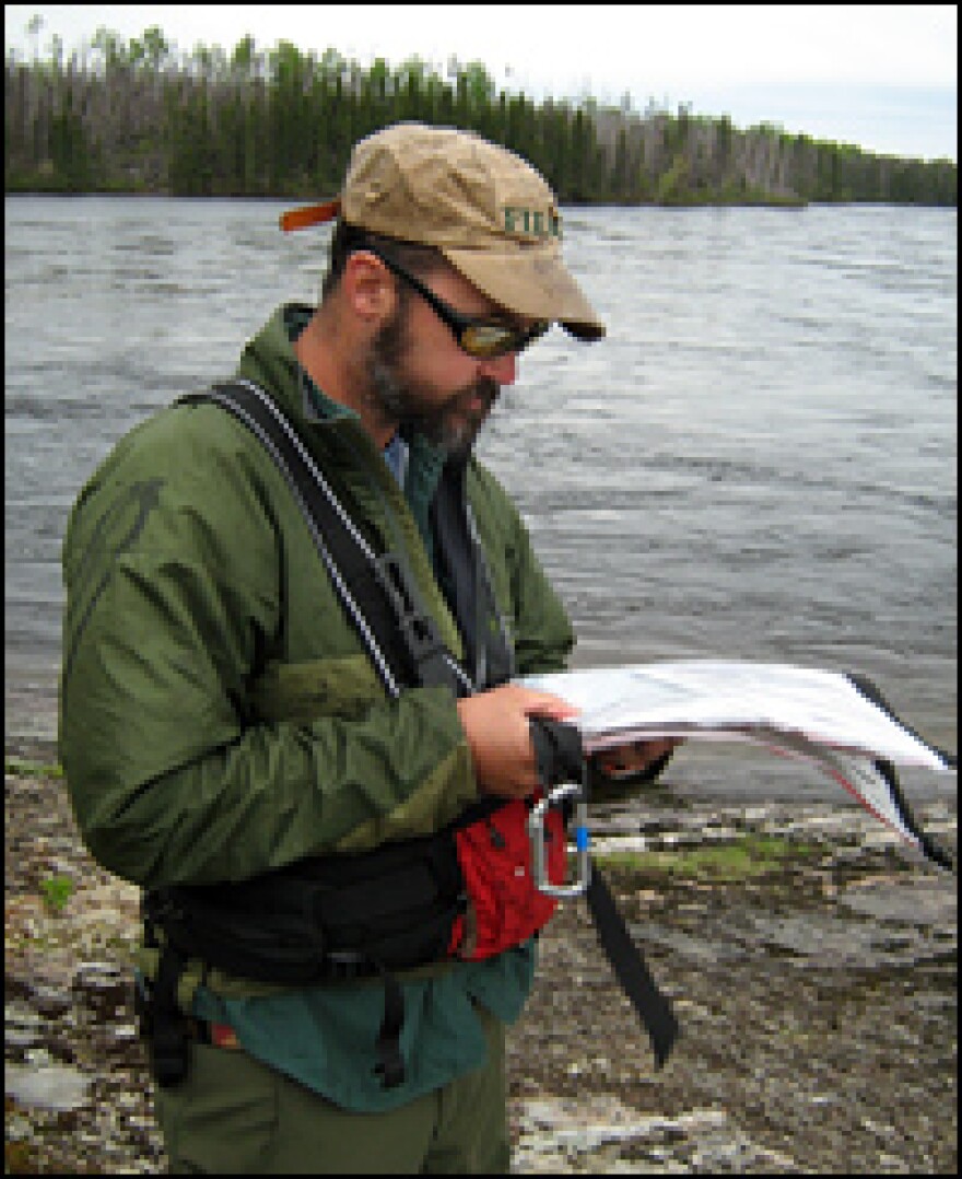 Phil Royce, an outdoor guide and geologist from St.  Lawrence University, charts the next set of rapids on the Rupert River.