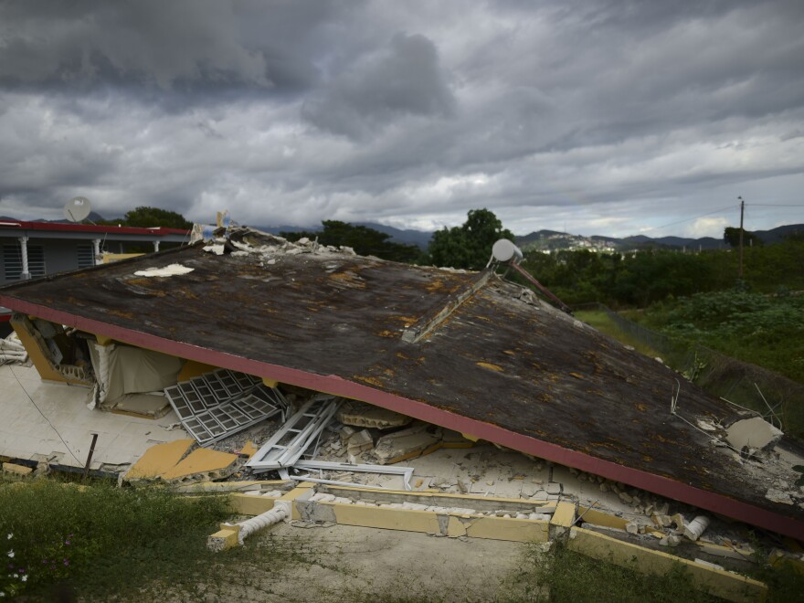 A collapsed structure lies after the previous day's magnitude 6.4 earthquake in Yauco, Puerto Rico.