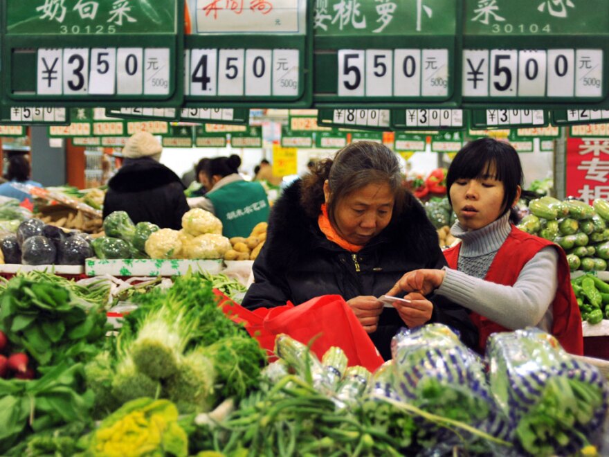 Chinese customers shop in the produce section of a supermarket in Beijing in December. Domestic food prices soared in 2010, driving inflation to a two-year high of 5.1 percent.