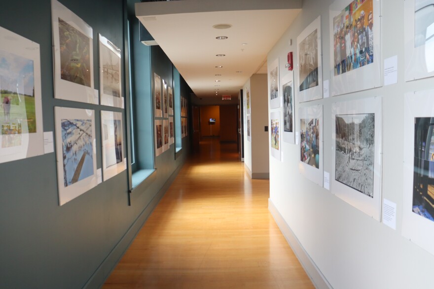 A long hallway of photos from the "Documenting Kentucky" exhibit at the Frazier History Museum