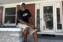 Anthony Wilson sits on his front porch on a Monday afternoon in late August after finishing his work shift.