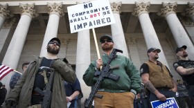 From left, Ian Stobie and Zach Kaczmarek of Puyallup listen to speakers during a March For Our Rights pro gun rally on Saturday, April 21, 2018, at the Washington state capitol in Olympia.