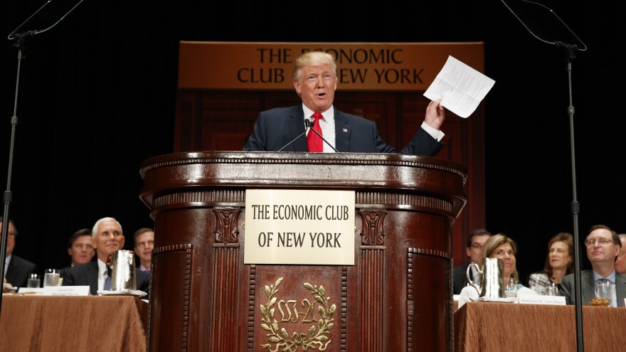 Donald Trump holds up notes as he speaks to the Economic Club of New York on Thursday.