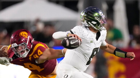 Oregon quarterback Dylan Raiola, right, passes while under pressure from Southern California defensive end Luke Wafle during the second half of an NCAA college football game, Saturday, Sept. 26, 2026, in Los Angeles. (AP Photo/Mark J. Terrill)