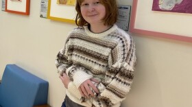 12-year-old Lexington artist Katie Carmichael poses near the art exhibit she created at Kentucky Children's Hospital featuring UK HealthCare's Animal-Assisted Therapy Dogs.