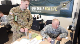 Army Captain Kellam Carmody discusses a recruit's aptitiude test with Army recruiter Kevin Mitchell at the Army Career Center in Tukwila, Washington.